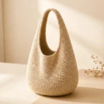 Ivory crochet shoulder bag with a rounded base and integrated curved handle