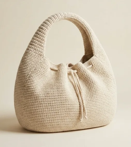 Natural cream structured crochet crescent handbag