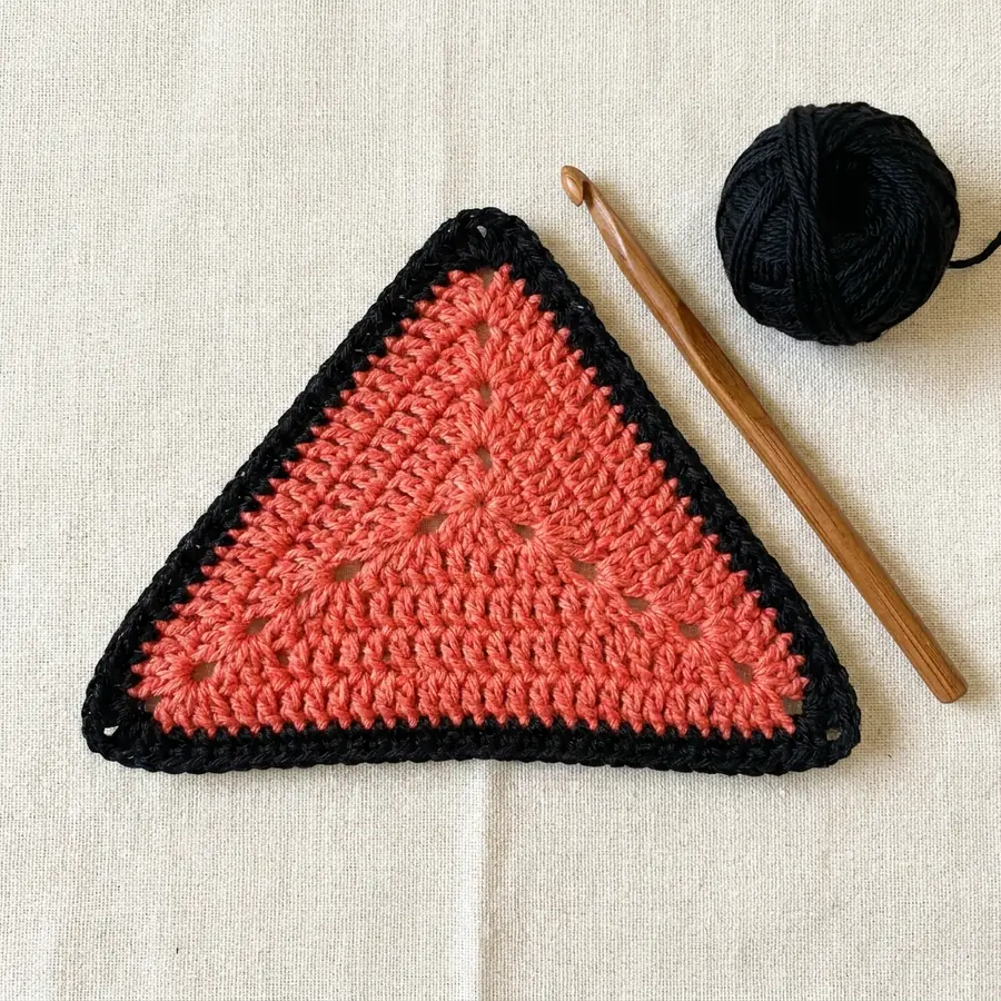 Round 3 with side clusters growing a solid crochet triangle motif