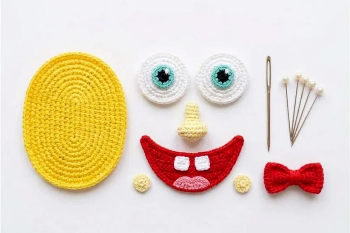 Add the eyes and nose for the Sunny Sponge crochet bottle holder