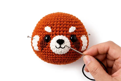 crochet red panda mushroom pattern step 15: Assemble the face