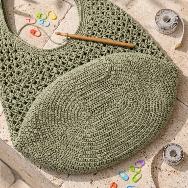 Sage green market bag pinned flat for wet blocking with the handles and corners shaped