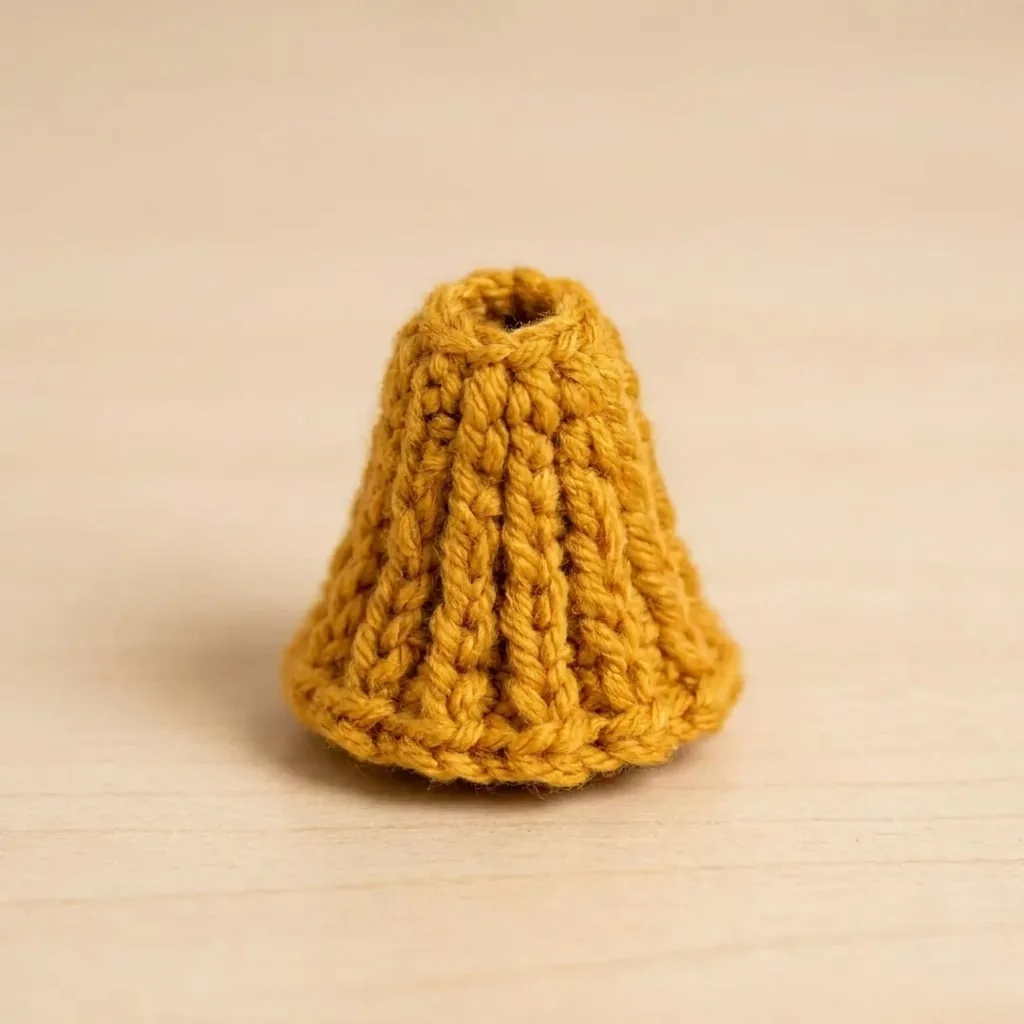 Finished mustard crochet broom bristle cone before assembly