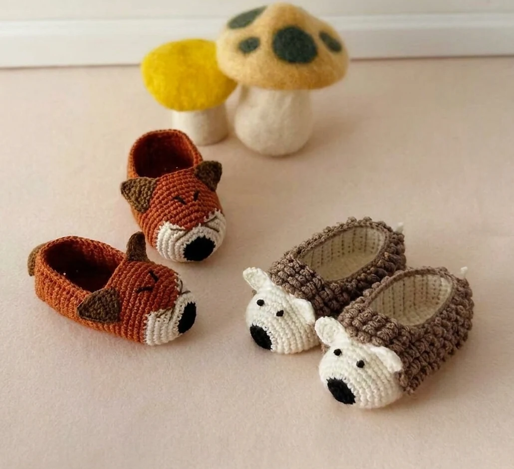 Animal baby booties in fox and hedgehog designs with embroidered faces