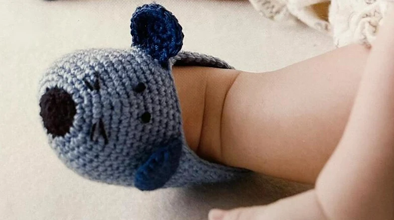 Blue mouse baby booties with navy ears and black embroidered features