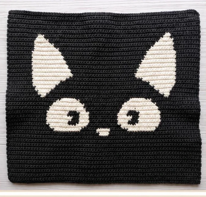 Right side of the black panel with cream ears eyes and nose