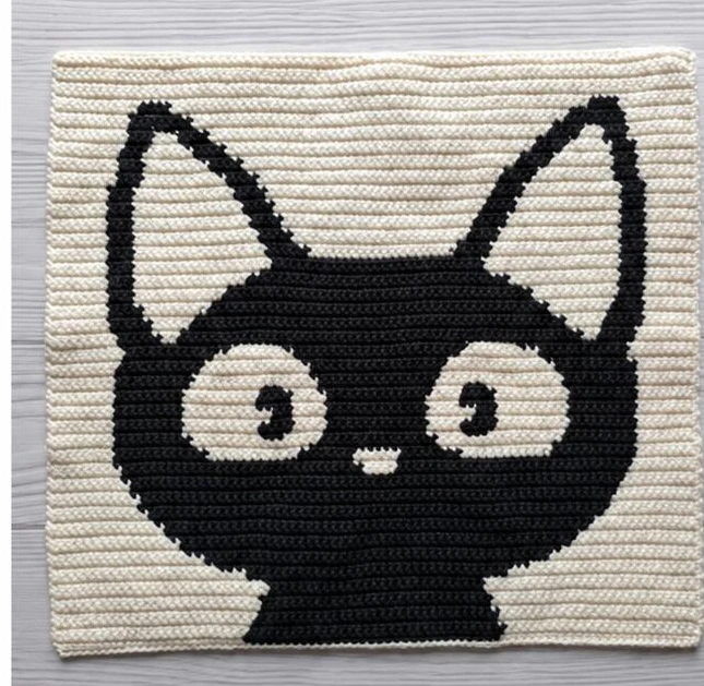 Right side of the completed cream panel with a black cat face