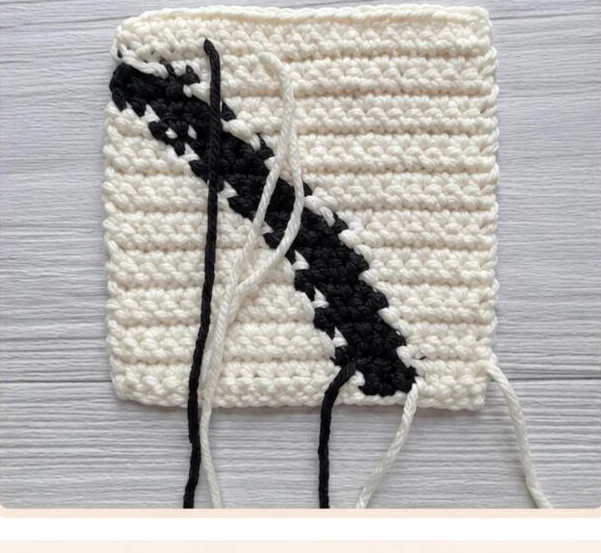 Wrong side of the practice swatch before weaving in yarn tails