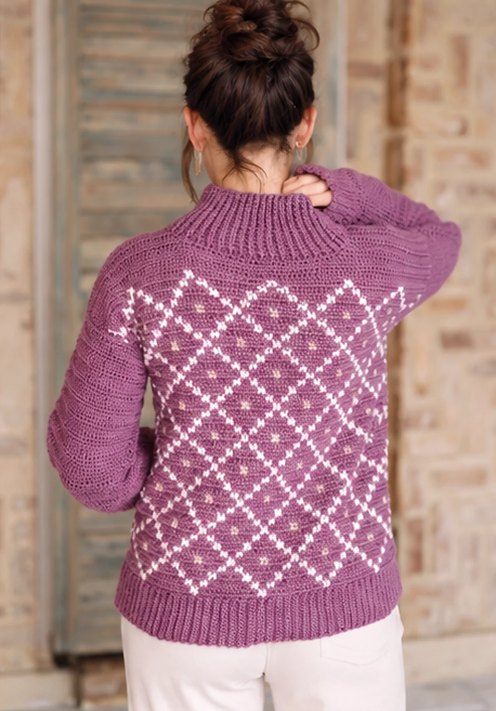 Back view of the cocoon neck crochet sweater showing the diamond motif and ribbed hem