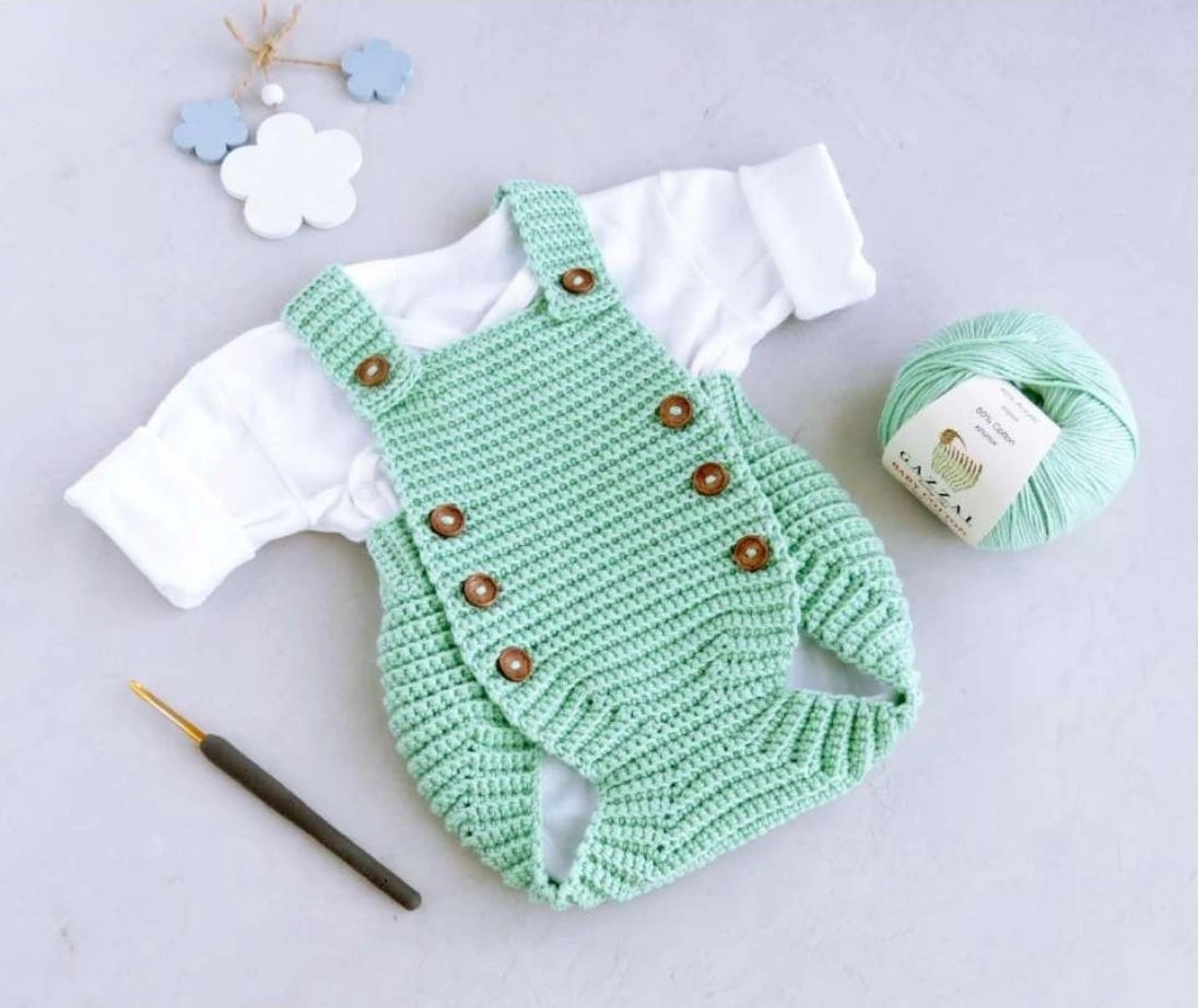 crochet baby romper pattern showing mint Tiny Tot romper with brown buttons