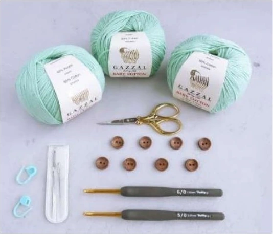 Sport weight mint yarn crochet hooks buttons scissors and stitch markers