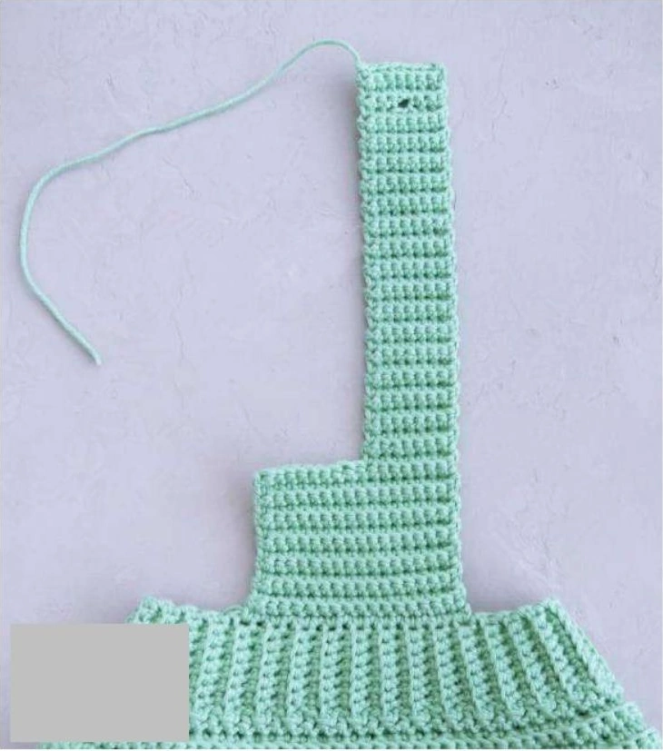 crochet baby romper pattern construction view showing narrow strap and ribbed edge