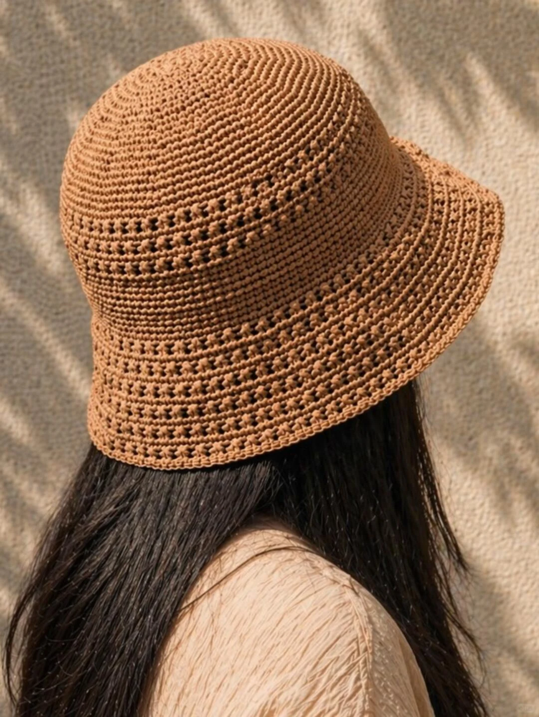 Caramel raffia bucket hat with textured bands and a gently flared brim