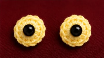 Two yellow outer eye discs with black eye components