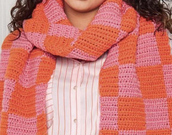 Original crochet plaid scarf pattern sample showing orange and pink blocks around the neck