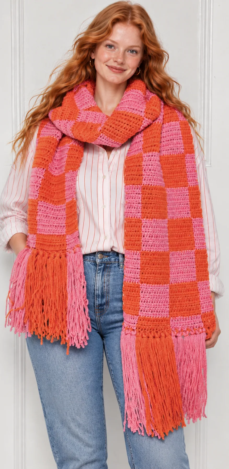 Original crochet plaid scarf pattern worn with a striped shirt and blue jeans