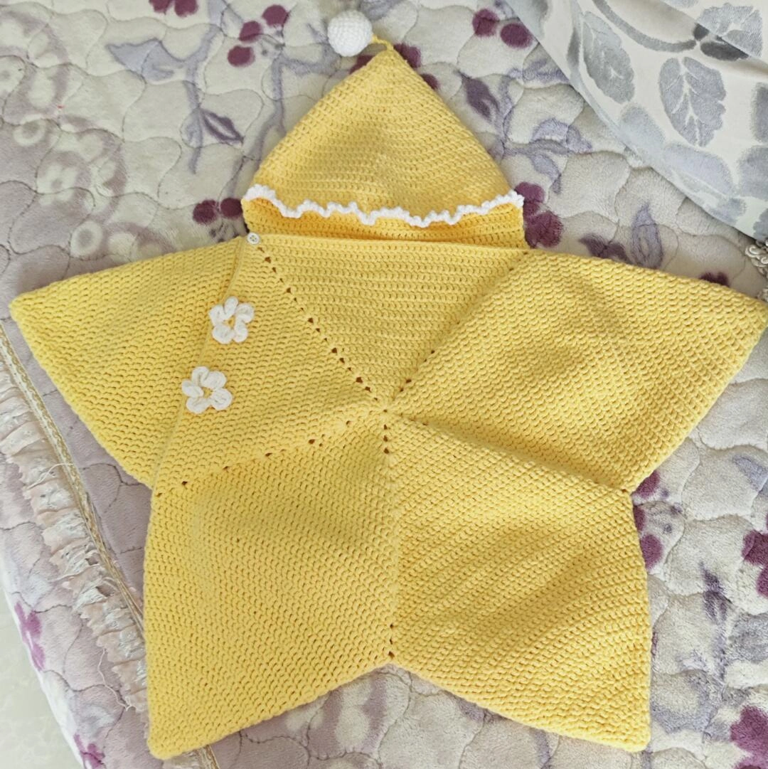Finished star-shaped yellow crochet baby wrap with white hood edging