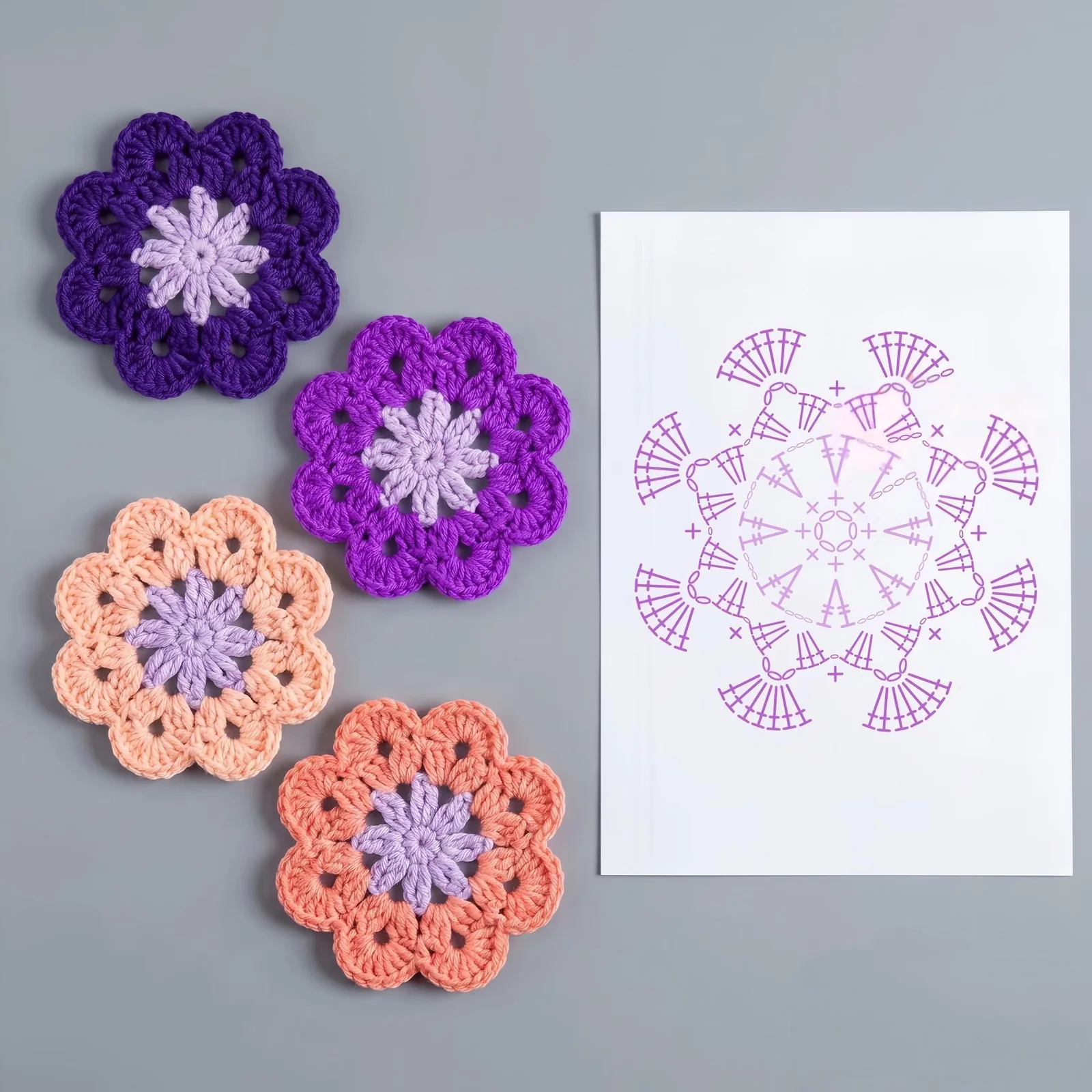Pastel five-lobed crochet flower coaster motifs with a round stitch chart