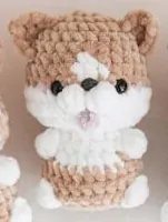 Tan and white crochet corgi with pointed ears and tiny paws