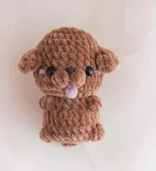 Brown crochet poodle with floppy ears and a pink tongue