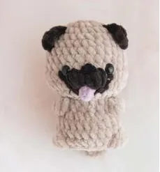 Beige crochet pug with dark ears and a dark muzzle