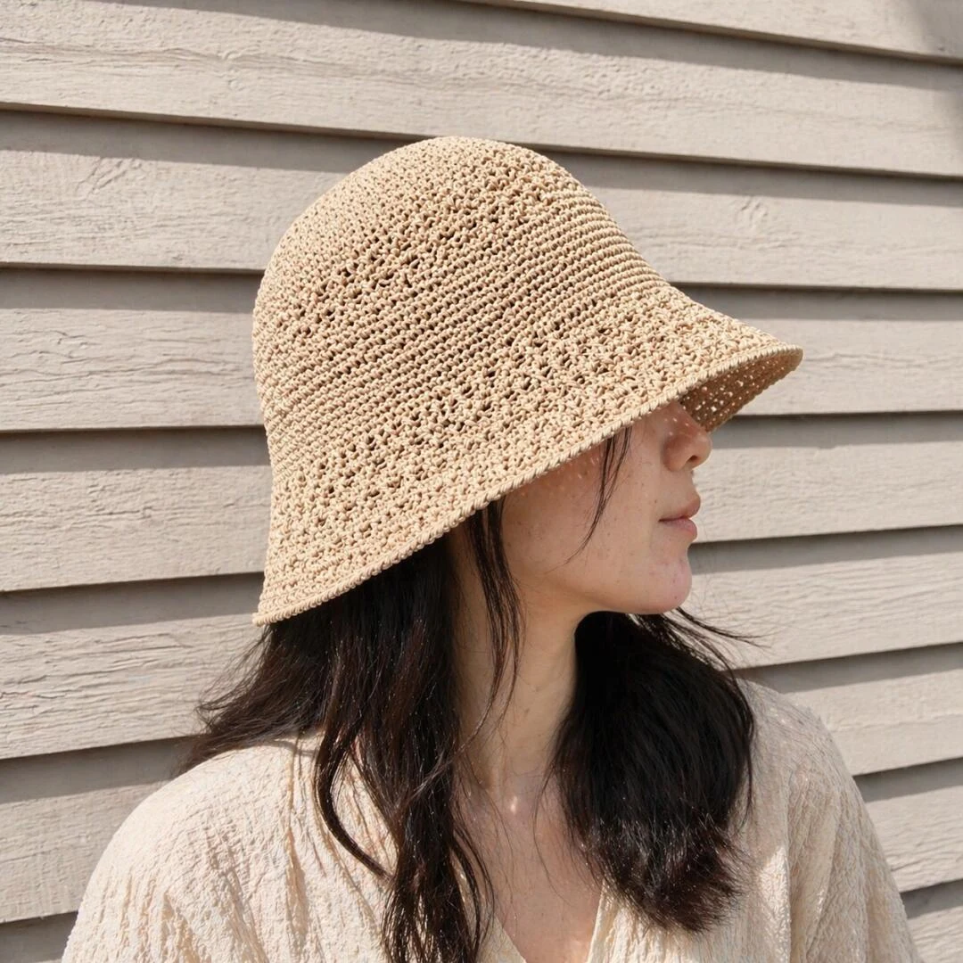 Beige crochet bucket hat worn in profile showing the crown and brim