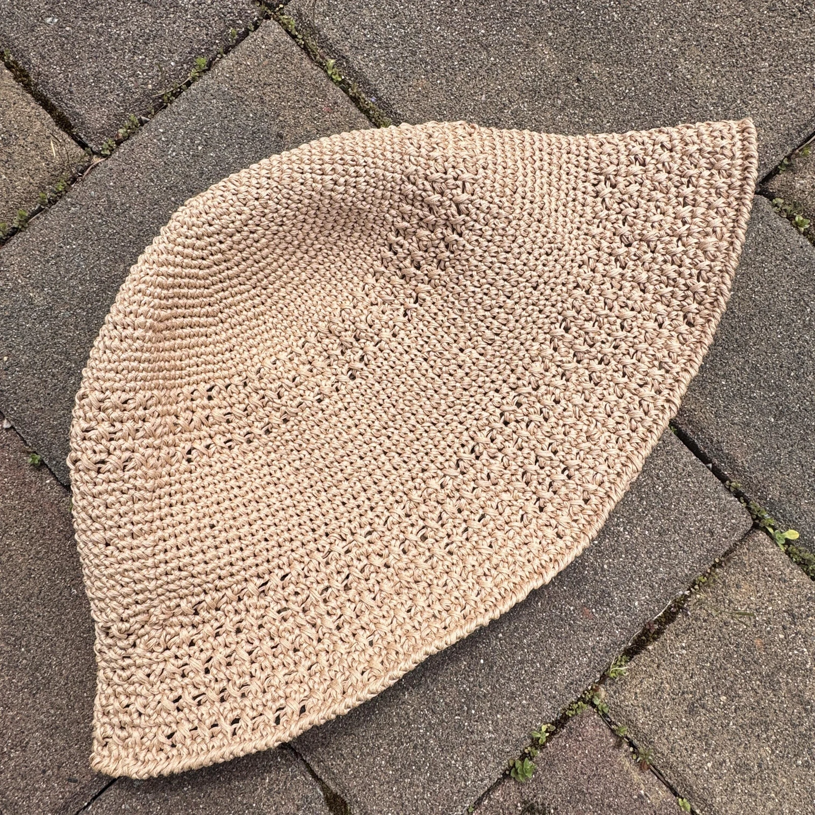 Flat raffia hat showing dense stitches and open textured bands