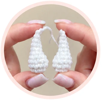 Pair of white crochet arms with flattened attachment edges