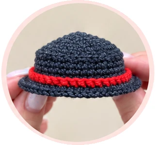 Completed red band around the dark gray snowman hat
