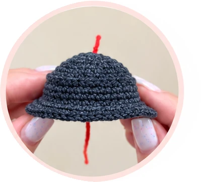 Dark gray crochet hat with its flared brim before adding the band