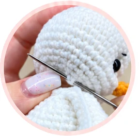 Sewing the head to the body around the neck