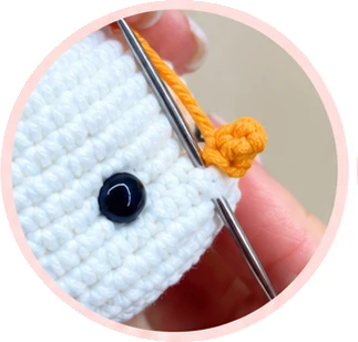 Attaching the orange carrot nose, photograph 2
