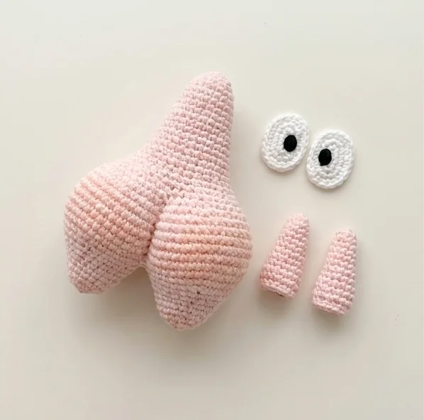 AI layout concept showing crochet starfish charm body, separate arms and white eyes