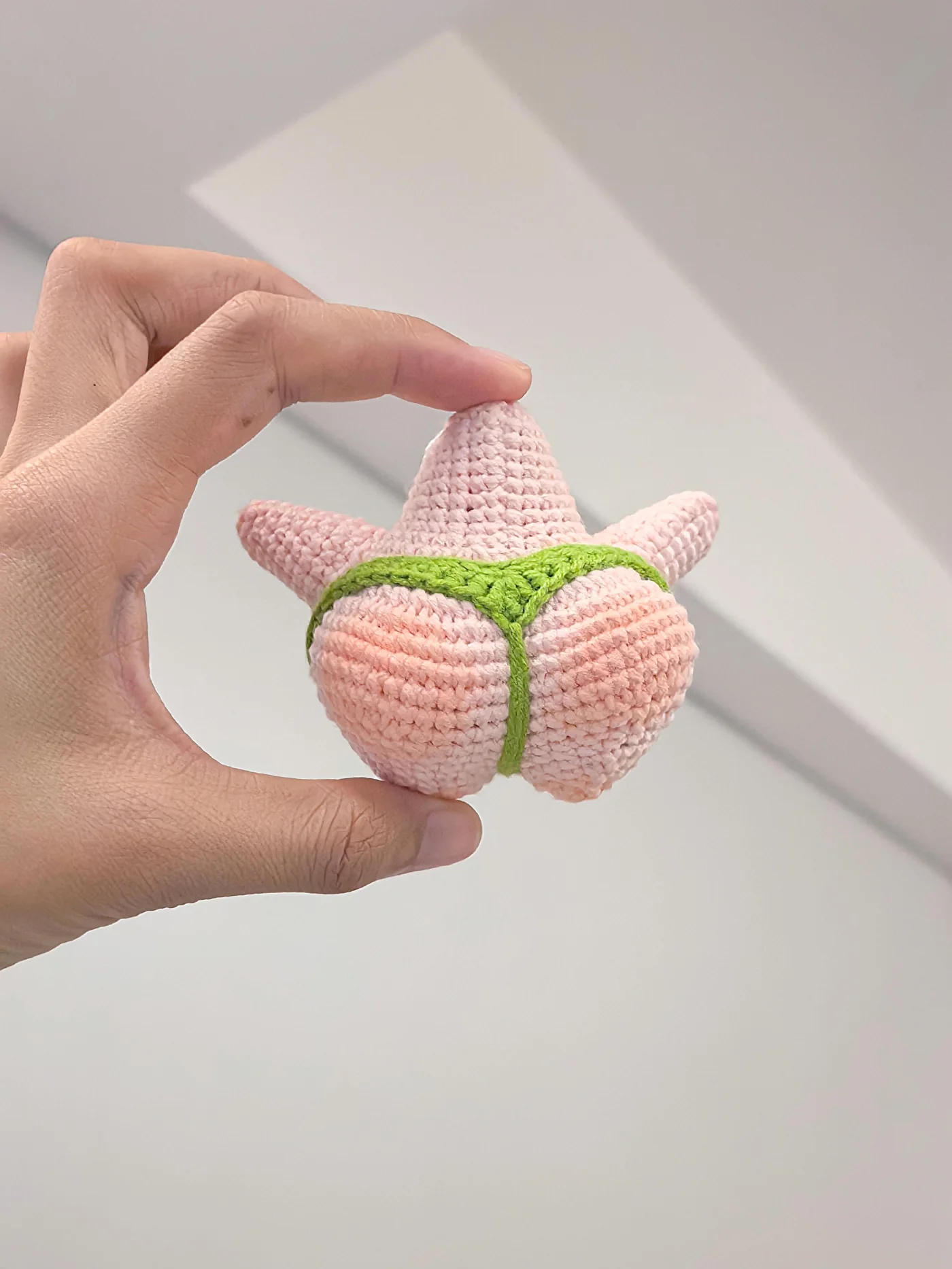 Real crochet starfish charm rear view showing green waistband and center strap